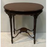 An Edwardian stained mahogany oval occasional table in the Adam style, with blind fret carved frieze
