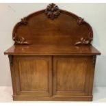 A 19th century mahogany chiffoniere with raised scrollwork back above a pair of panelled doors