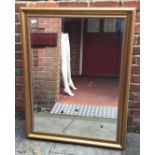 A large rectangular gilt framed bevelled glass mirror with beading detail, 117 x 90cm