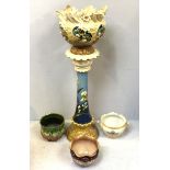 A floor standing Leeds Art Pottery jardiniere and pedestal decorated with flowers to cream and