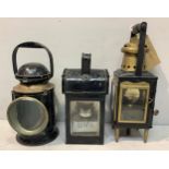 Three various railway oil lamps including a GWR oil lamp in black painted metal with applied