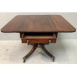 A Regency mahogany drop-leaf table with deep end drawer and opposing faux drawer, raised on turned