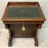 A Victorian rosewood Davenport with slope front enclosing pigeon-hole satinwood veneered drawers,