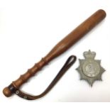 A chrome Portsmouth City Police cap badge together with a turned wooden truncheon and leather strap