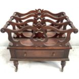 A Victorian mahogany three-sectioned Canterbury, with open lyre shaped divisions and turned handles,