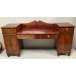 A 19th century break-front mahogany sideboard with zebra wood cross-banding, a pair of central