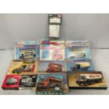 A collection of 14 boxed model kits from various manufacturers including six vehicles by Keil