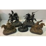 A pair of black painted spelter soldiers on horseback, with swords raised and horses rearing, on