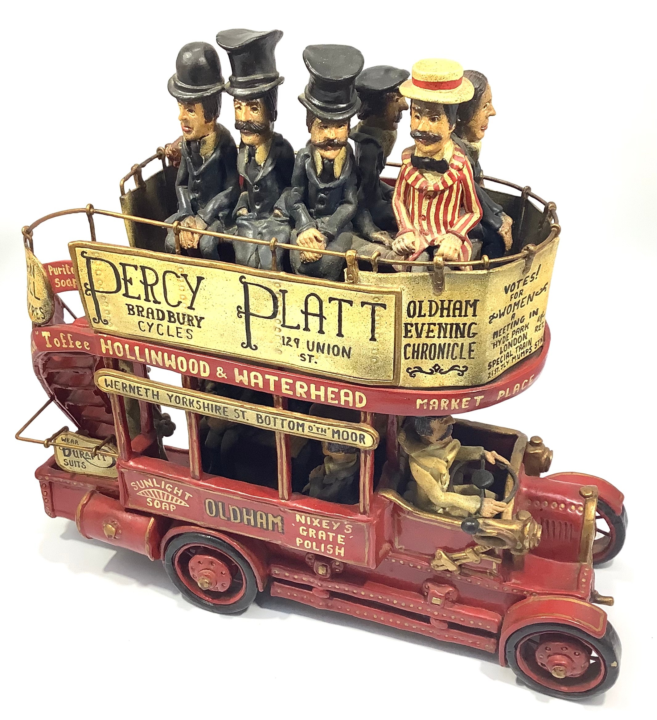 A novelty model of an open-topped double decker bus with seated figures in Victorian dress top and