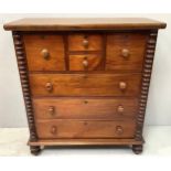 A 19th century North Country chest of drawers with two small central drawers flanked by a hat drawer