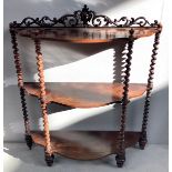 A Victorian rosewood three-tier what-not with serpentine shaped shelves and barley twist supports