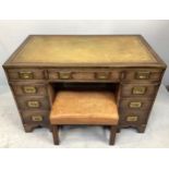 A campaign 'style' twin pedestal desk, with green leather tooled scribe, brass bound top and semi-