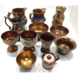 A collection of 12 pieces of Victorian copper lustre ware pottery including a squire jug