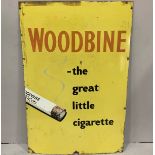 A large yellow enamel advertising sign for 'Woodbine - the great little cigarette' with fixing