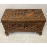 A heavily carved camphor-lined Chinese chest / blanket box, of small proportions, carved with
