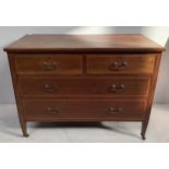 An Edwardian inlaid mahogany chest of two short and three long drawers with brass handles, raised on