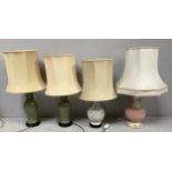 A pair of Celadon pottery table lamps of inverted baluster form, raised on carved wooden bases,