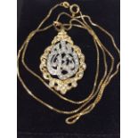 A middle-eastern bi-colour metal pendant, testing as 18ct or above, of Islamic calligraphy design,