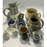 A quantity of jugs including a Wedgwood Jasperware jug with brown ground, Copeland Queen Victoria