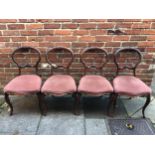 A set of four Victorian stained walnut balloon back standard chairs, each with fabric stuff over