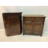 An Edwardian oak cupboard with a pair of arcade-carved front panel doors enclosing three inner