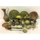 A large quantity of brass and copperwares including a set of scales, watering can, teapots,
