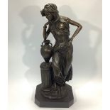 A bronze figure of a Grecian maiden with Amphora vase resting on short fluted column , signed '