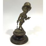 A 1920's brass Sir Kreemy Knut car mascot depicting a snooty gentleman wearing a suit, bowler hat