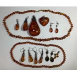 A small collection of assorted amber jewellery items including pendants, necklaces and earrings etc.