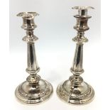 A pair of 'Old Sheffield Plate' silver-plated candlesticks with removable sconces, raised on