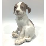 A large Royal Copenhagen porcelain figurine of a seated Pointer puppy by Erik Nielsen, marked to