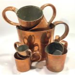 A harlequin set of eight Naval copper rum / grog measures including gallon, 1/2 gallon, quart, pint,