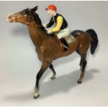 A Beswick racehorse and jockey 'Walking Racehorse' No. 1037, jockey with black and yellow jersey and