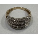A 9ct gold and diamond ring, seven stepped rows of rose-cut diamonds in tapering band milli-grain
