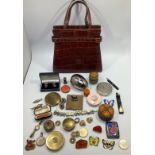 A mixed lot including a crocodile skin handbag with suede lining, seven various compacts including a