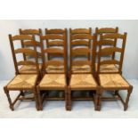 A set of eight oak ladder back dining chairs with rush seats on turned supports and central cross
