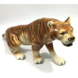 A large porcelain model of a Tiger by Royal Dux, in a prowling pose, painted underglaze, with raised