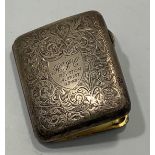 A silver cigarette case with foliate case, central shield cartouche engraved 'HJC Royston August