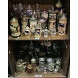 A collection of approximately 50 assorted pottery, glass and wooden beer steins, many with typical