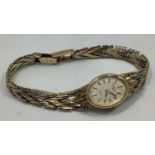 A ladies 9ct gold cocktail watch by Rotary, with quartz movement, oval silvered dial with batons