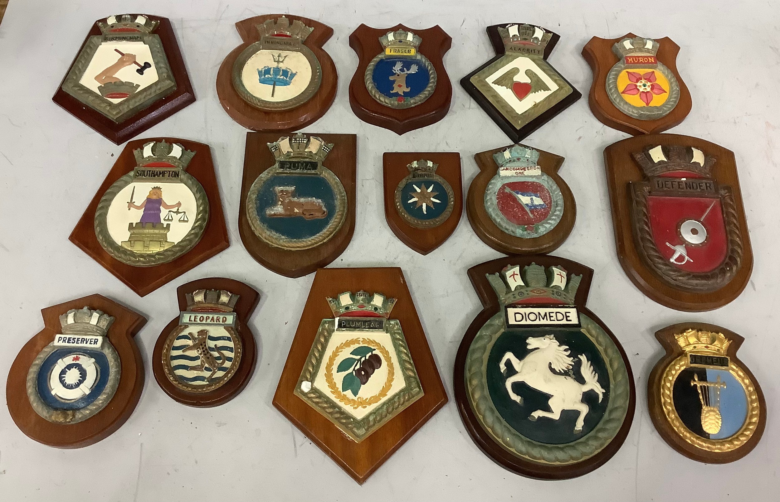 15 various plaster ships crests including Defender, Orpheus, Diomede, Plumleaf, Leopard, Birmingham,