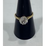An 18ct gold ladies ring claw-set with a large brilliant cut clear white stone, possibly a white