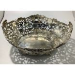 A late Victorian silver fruit basket of large oval form, with continuous pierced and chased