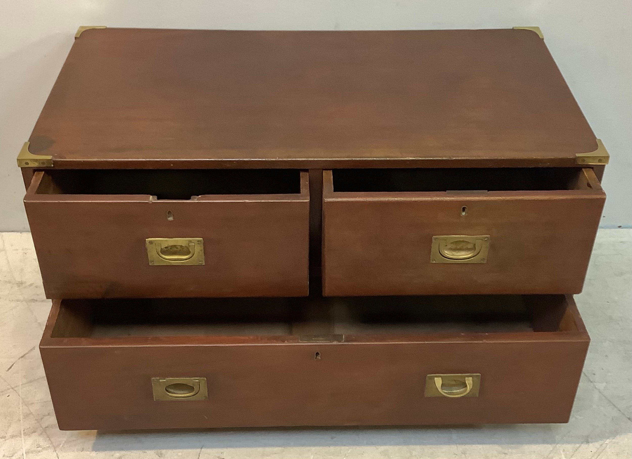 A mahogany campaign chest of two short over one long drawers, brass corners, flush brass handles