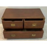 A mahogany campaign chest of two short over one long drawers, brass corners, flush brass handles