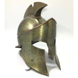 A reproduction bronzed Greek gladiator helmet, with strap work interior and chin strap