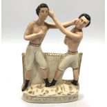 A reproduction Staffordshire pottery figure group of pugilists Heenan & Sayers depicting the