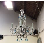 A Murano glass chandelier with five sconces and cut glass beaded frame, decorated with swags of