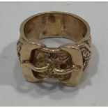 A large 9ct gold gents buckle ring, with carved scroll-work decoration, size Z-5, 29.1g