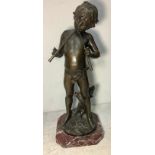 A large bronze figure of a young boy playing the pipes standing on a tree stump, signed 'Aug